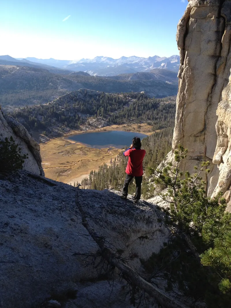 A hiker above a lake in the High Sierra in fall