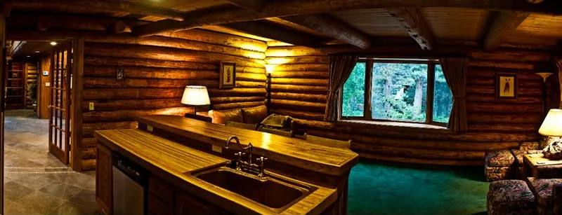 The family room and its wood stove on a fall evening at the chalet