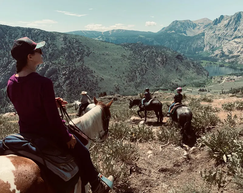 A family on horseback on a ridge high above Silver Lake and the June Lake Loop