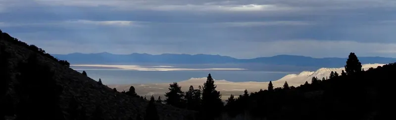 Looking back at Mono Lake and the Mono Craters from high above Fern Lake, under a storm-lit sky